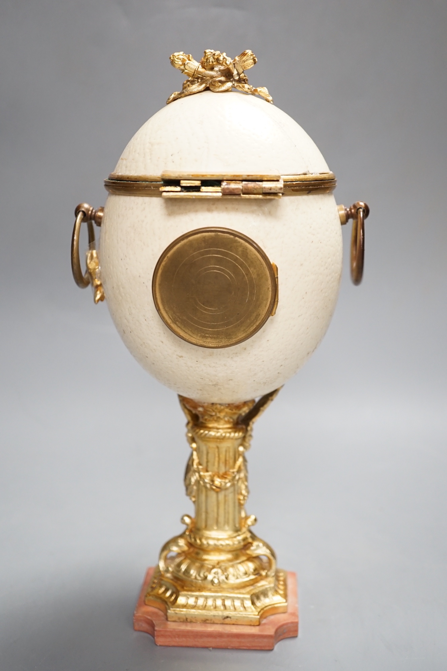 An unusual late 19th/early 20th century ostrich egg timepiece with encased compass and barometer - key included, 29cm high
